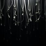 Tangled cables suspended in shadowy light, symbolizing the complexity of remote file security without IT guidance
